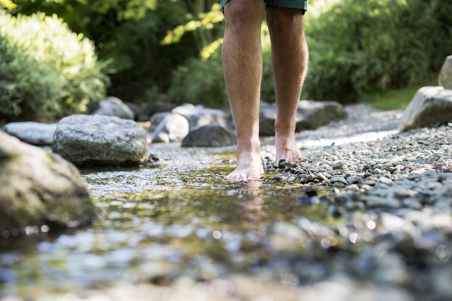 Barefoot through a torrent on the Alpe di Siusi